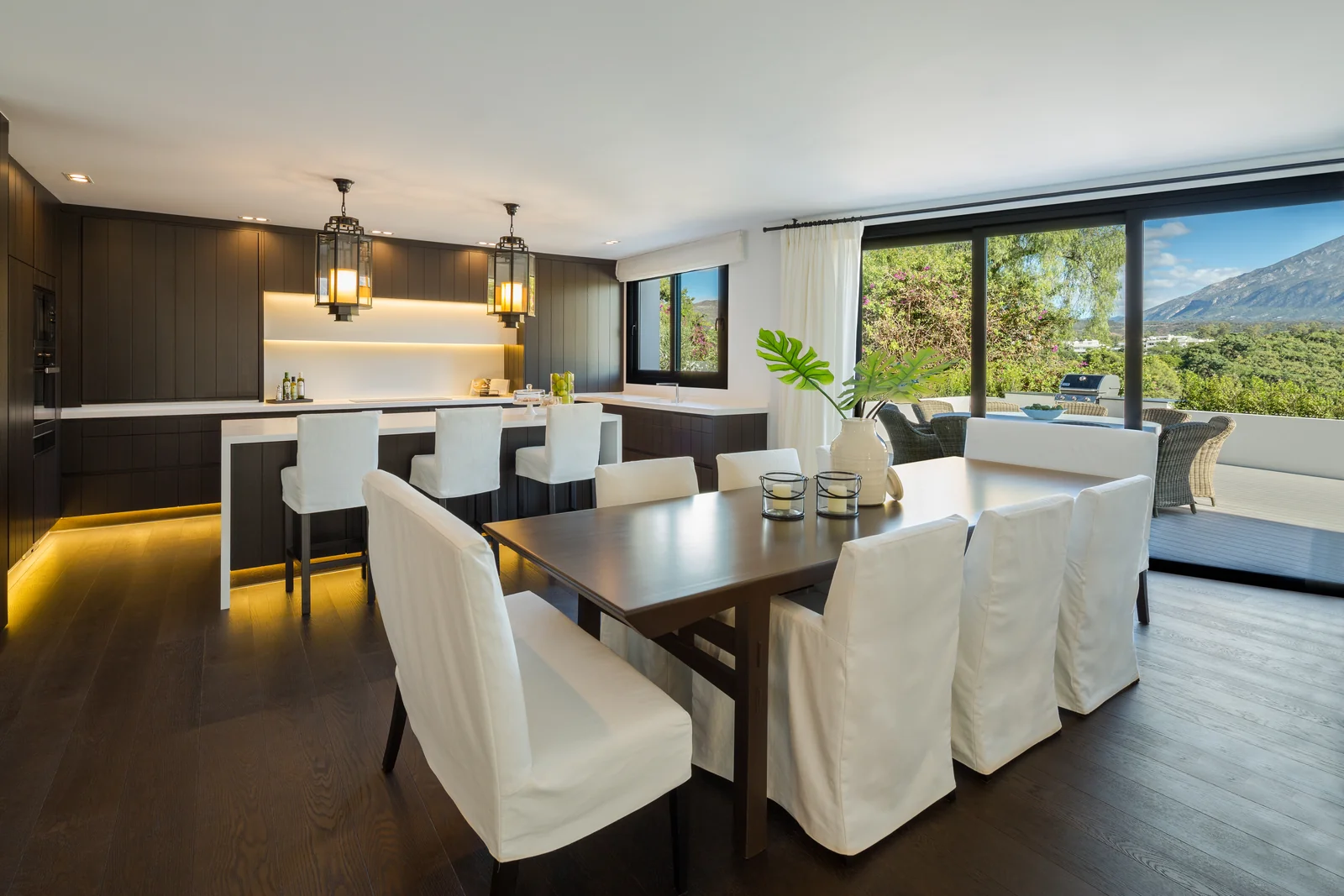 Open kitchen with island and dining area beside a window with a view