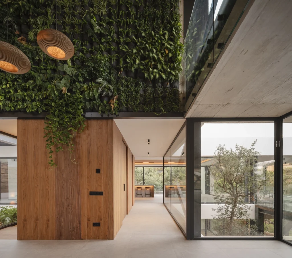 Interior de Villa Madroñal 14 con jardín vertical y cristaleras