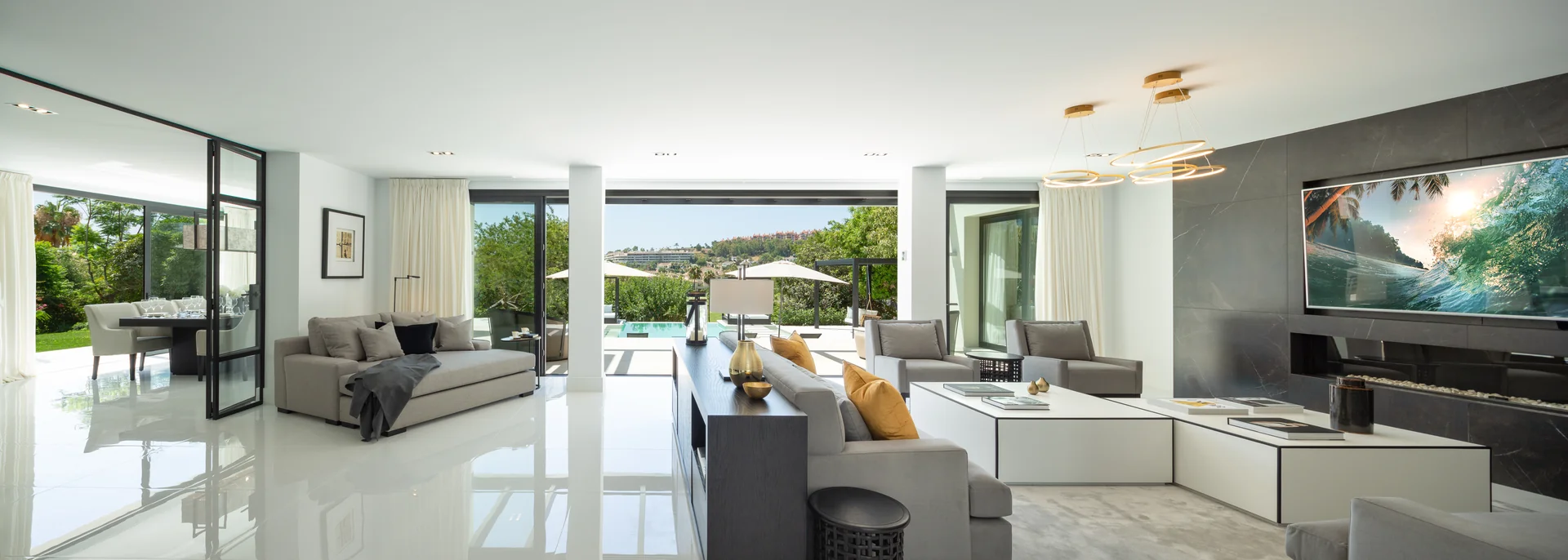 Open-plan living room with panoramic windows onto the garden