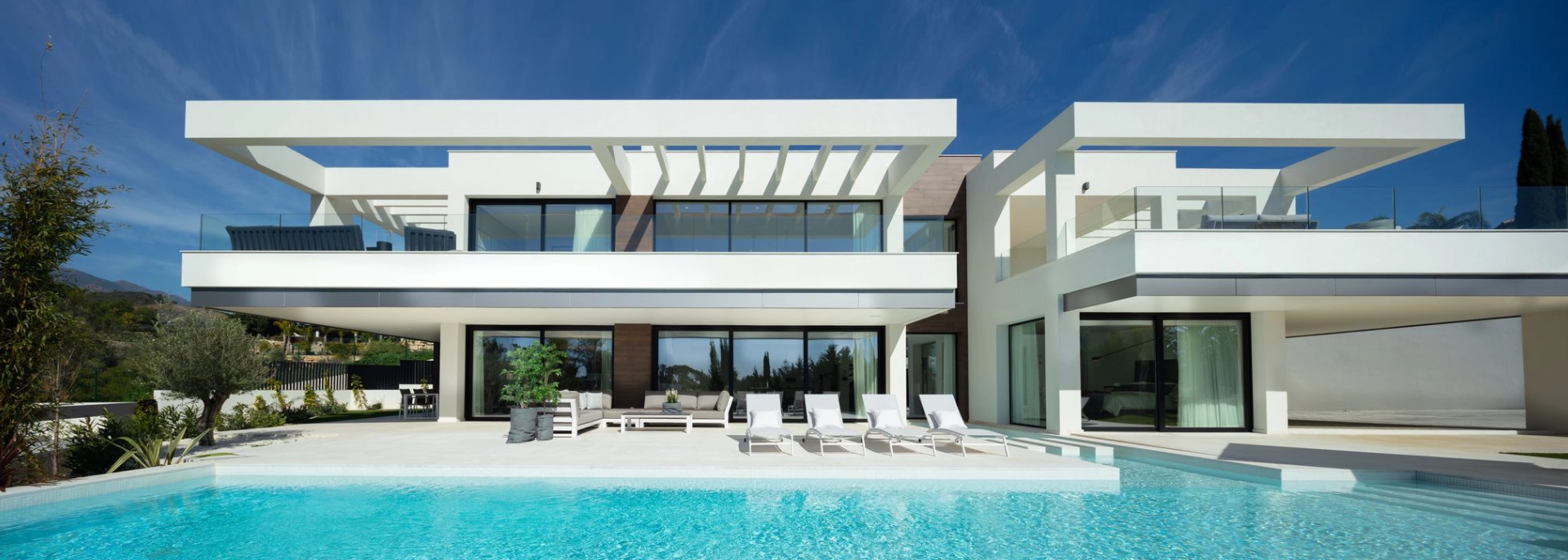 Contemporary white villa with large swimming pool, following renovation