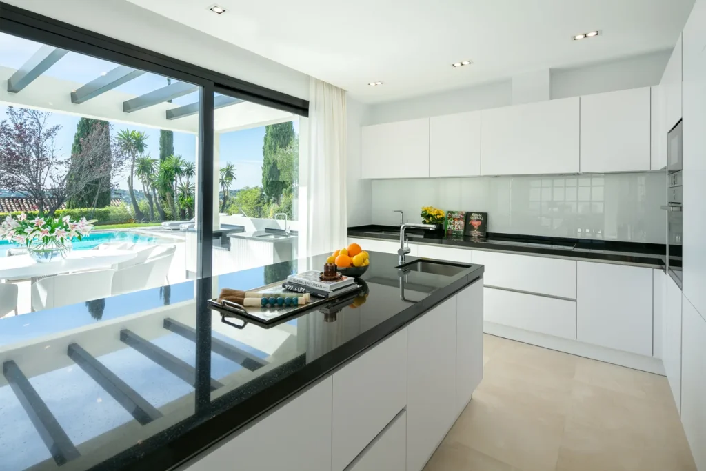 White kitchen with an island at Villa Begoña