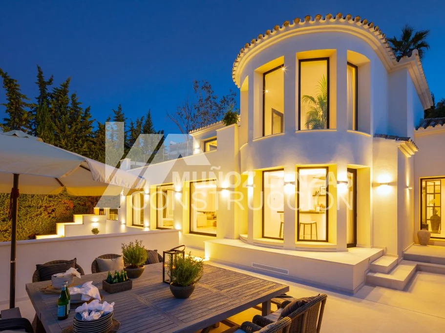 Villa Karma, terrace and illuminated façade at dusk
